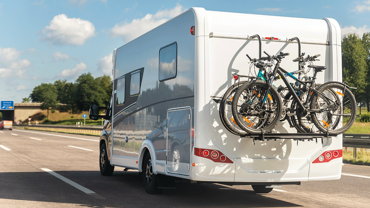 Vue arrière d'une roulotte avec rack à vélo sur route avec inspection de pneu faits